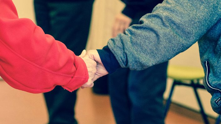 2-persons-holding-hands